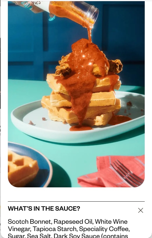 Waffles with hot sauce above an open ingredients panel, on a phone
