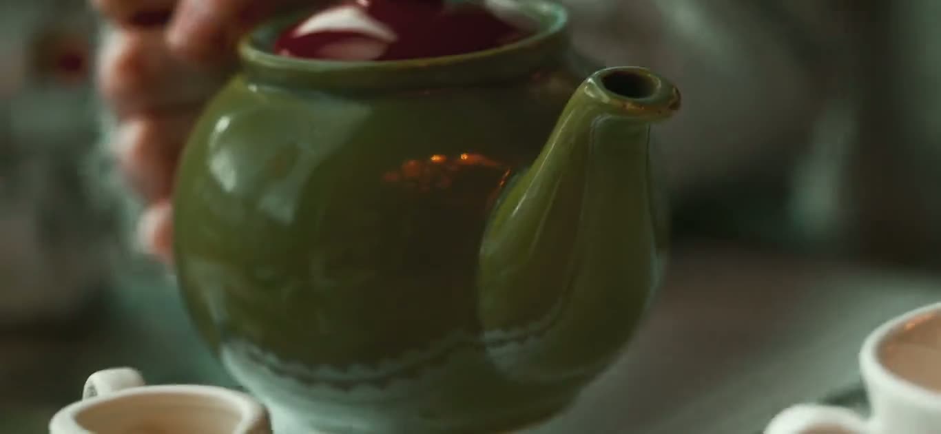 Tea poured from a pot in a café