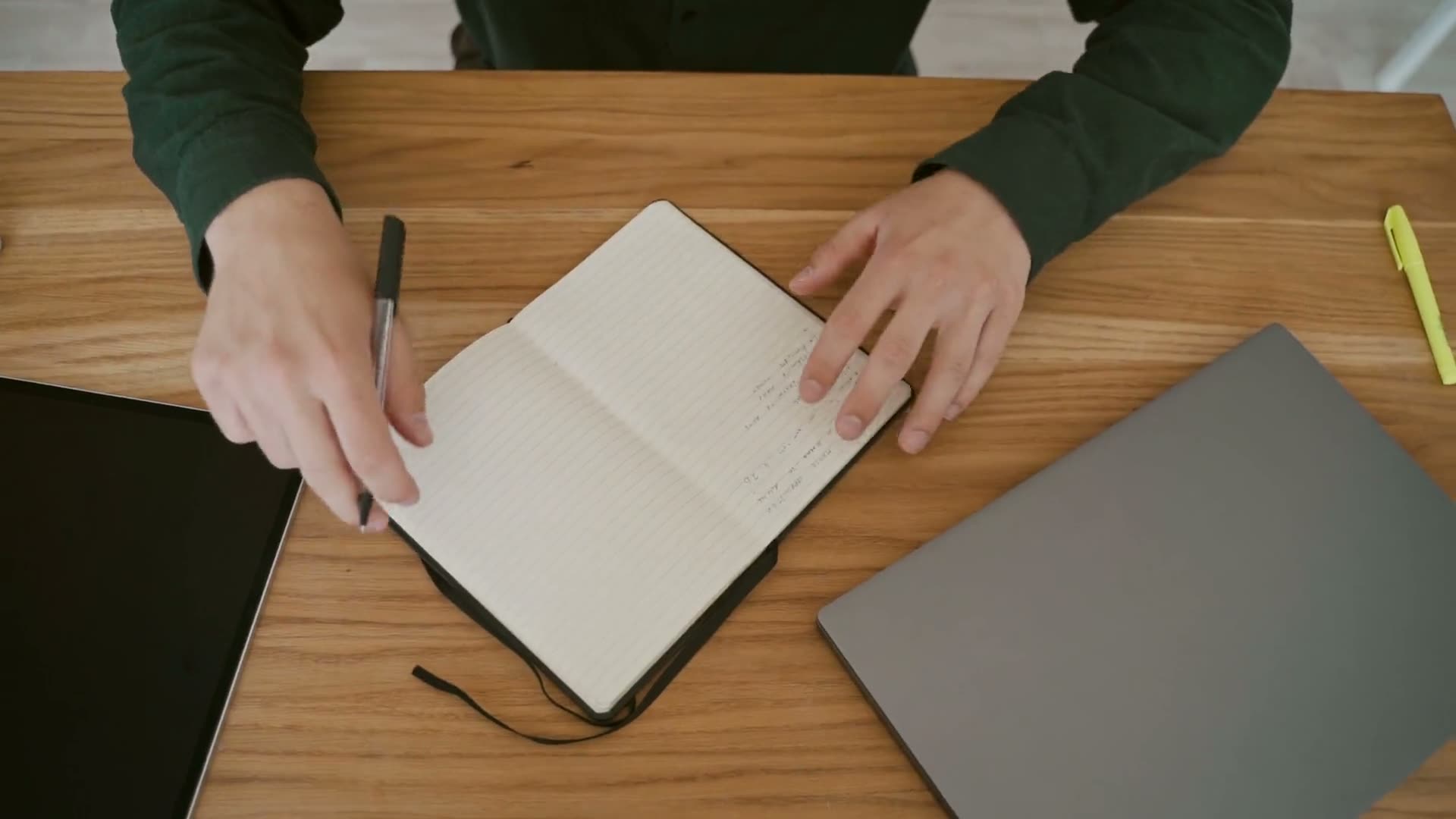 Someone writing in a notepad