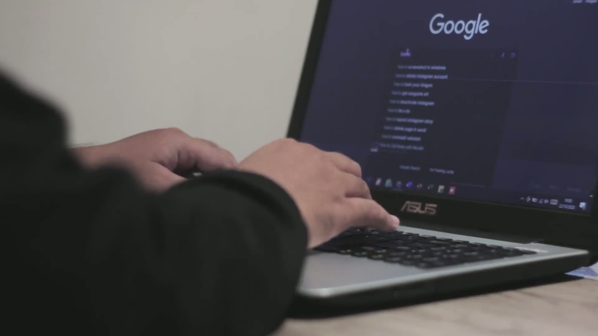 Someone typing on a laptop