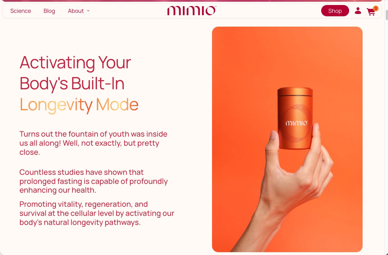 A hand holding the orange Mimio canister on a cream background
